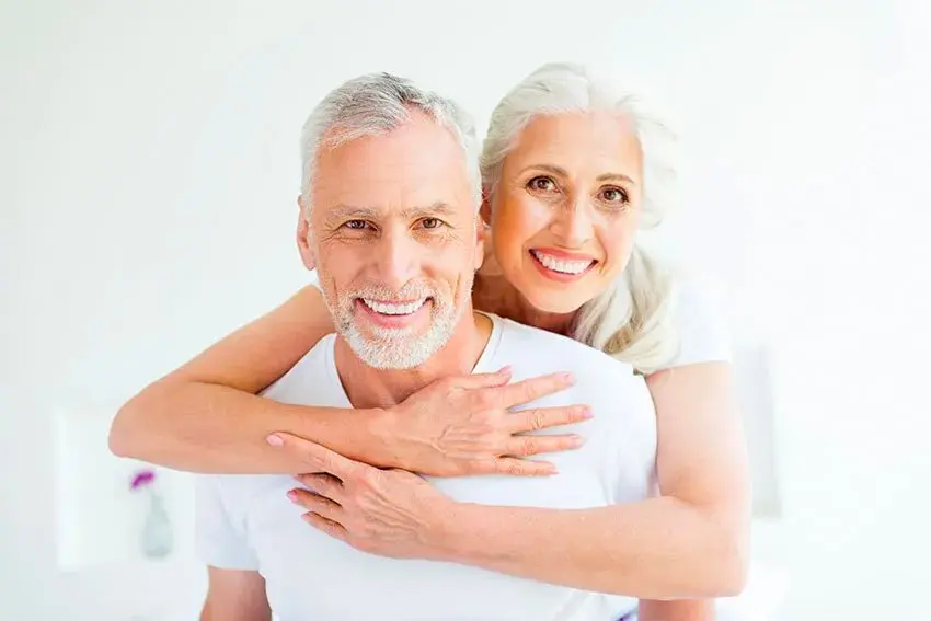 Mature couple posing for a picture, smiling