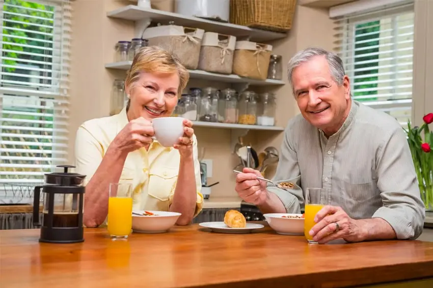 6 Ways Your Daily Life Is Affected by Dentures-min Mature couple enjoys breakfast together