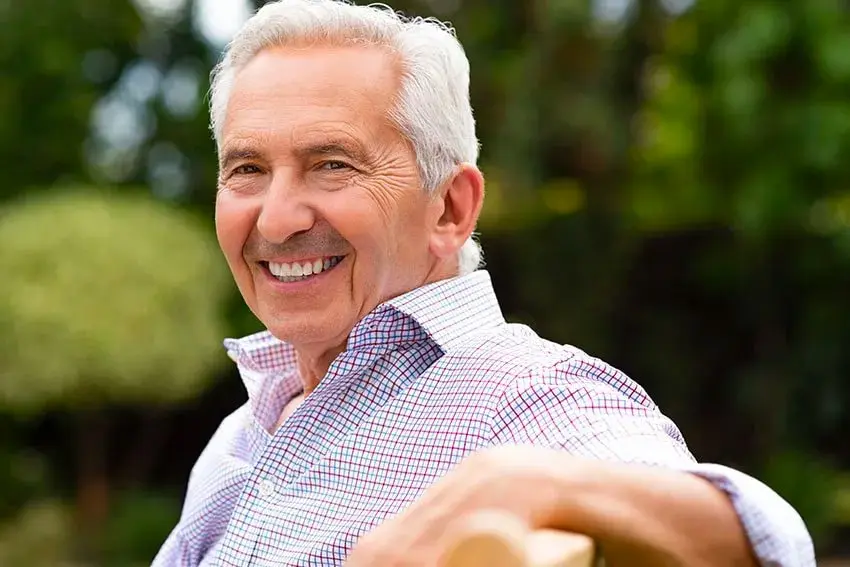 Benefits of Dental Implants Even Greater Now_-min senior man relaxing on a park bench
