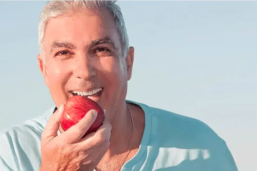 Man about to eat an apple