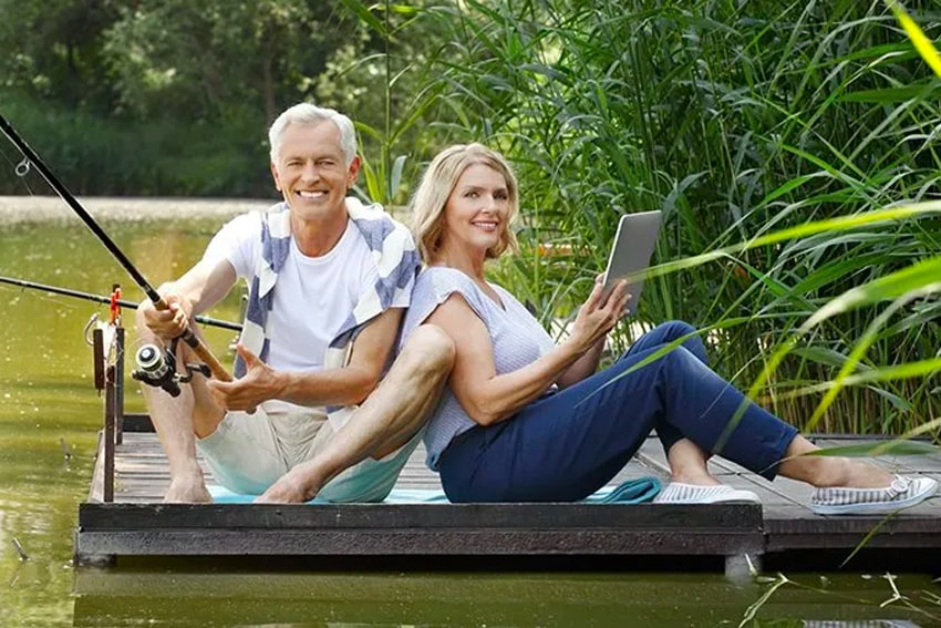 Mature couple fishing and enjoying the lake