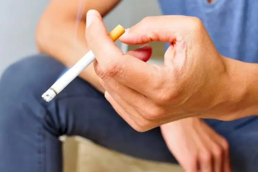 Teeth Are Wasted on the Young-min A man’s hand holding a cigarette