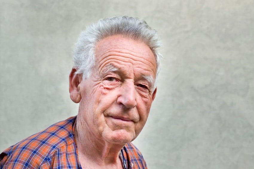 Old, gray haired man in flannel shirt