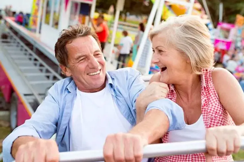 Mature couple enjoying a roller coaster