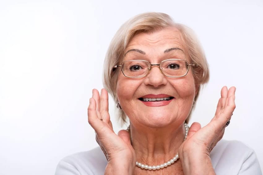 Older woman framing her face & smile
